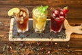 Three glasses of different cold tea drinks black, green with lemon and mint, hibiscus teas. Royalty Free Stock Photo