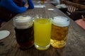 Three glasses of different types of cold tasty beer are in a row on a wooden table Royalty Free Stock Photo