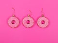 Three glasses donuts on pink background. Christmas toy: pink donats. Merry Christmas and Happy New Year concept. Royalty Free Stock Photo