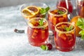 Three glasses of Italian aperol spritz cocktail with orange slices and ingredients on light gray stone table. Summer drink,