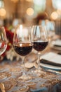 Three glasses of red wine on a dining table with candles Royalty Free Stock Photo