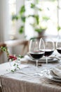 Three glasses of red wine on a dining table with candles Royalty Free Stock Photo