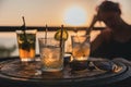 three glasses on a table, one is filled with a drink and some strawberries Royalty Free Stock Photo