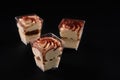 Three glasses with tiramisu isolated on black. Royalty Free Stock Photo