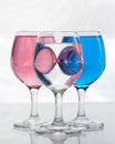 Three glasses of water with pink and blue Royalty Free Stock Photo