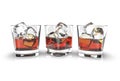 Three glasses of whiskey with ice cubes isolated on a white background.
