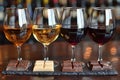 Three Glasses of Wine and Three Chocolates on a Table Royalty Free Stock Photo