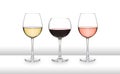 Three glasses of wine, white, red and rose, on a white bar like surface, with a white background and graduated tint Royalty Free Stock Photo