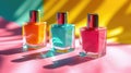 Three glossy nail polish bottles in orange, teal, and pink bask under a warm, sunny glow, casting playful shadows on a Royalty Free Stock Photo