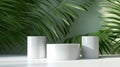 Three glossy white round cylinder podium in corrugated side, green tropical bamboo palm in sunlight, leaf shadow on wall for