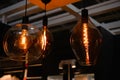 Three glowing vintage light bulbs of different shapes. Fashionable modern round lamp in retro style