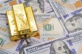 Three gold bar with hundred dollar bills Royalty Free Stock Photo
