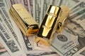 Three gold bars on dollar bills Royalty Free Stock Photo