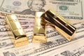 Three gold bars on dollar bills Royalty Free Stock Photo
