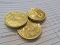 Three gold coins of Australian dollars on invoice sheet Royalty Free Stock Photo