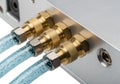 Three gold connectors with blue cables Royalty Free Stock Photo