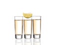 Three gold tequila shots with lime isolated Royalty Free Stock Photo