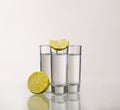 Three gold tequila shots with lime isolated on white Royalty Free Stock Photo