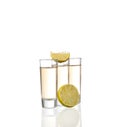 Three gold tequila shots with lime isolated on white background Royalty Free Stock Photo