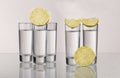 Three gold tequila shots with lime on white background Royalty Free Stock Photo