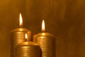 Three golden candles burning