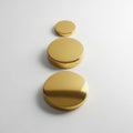 Three golden circular objects in ascending size Royalty Free Stock Photo