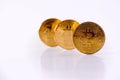 Three Golden Crypto Bitcoin Coins Stands On The Table Isolated On White Background. Copy Space Royalty Free Stock Photo