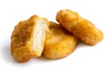 Three golden deep-fried battered chicken nuggets isolated on whi Royalty Free Stock Photo