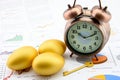 Three golden eggs and a golden key with a clock on business and financial reports. Royalty Free Stock Photo