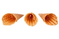 Three golden empty crispy ice-cream waffle cones on white background isolated close up top view Royalty Free Stock Photo