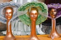 Three Golden Mannequin Heads with Fancy Hats