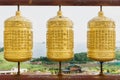 Three golden prayer wheels at Sanbanggulsa temple, Sanbang-ro, Jeju Island, South Korea