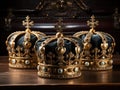 three golden royal crowns with precious stones with blue velvet