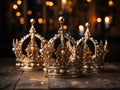 three golden royal crowns with precious stones with