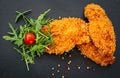 three golden schnitzels presented on a black platter Royalty Free Stock Photo
