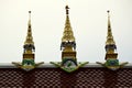 Three Golden Spires on a Temple Roof in Thailand