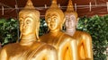 Three golden statues of Buddha.