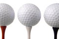 Three golf balls on tees Royalty Free Stock Photo