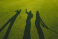 Three golfers silhouette on grass Royalty Free Stock Photo