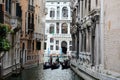 Three gondolas on narrow street