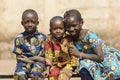 Three gorgeous African black ethnicity children posing outdoors