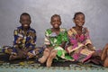 Three Gorgeous African Black Schoolboy and Schoolgirls Sitting Indoors