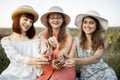 Three gorgeous female friends, enjoy picnic, showing delicious food, tasty roasted escargots