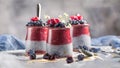 Three gourmet chia seed desserts with berry puree and fresh berries on a stained table, embodying indulgence