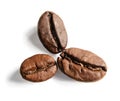 Three grains of coffee lie like flower petals. Macro. White isolated background.