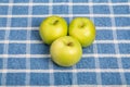 Three Granny Smith Apples on Blue Plaid Towel Royalty Free Stock Photo