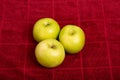 Three Granny Smith Apples on Red Towel Royalty Free Stock Photo