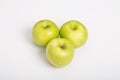 Three Granny Smith Apples on White Counter Royalty Free Stock Photo