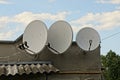 Three gray satellite dishes on a concrete wall Royalty Free Stock Photo