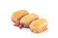 Three greek pastry Kataifi with shredded filo dough stuffed with almond nuts, in honey syrup, isolated on a white